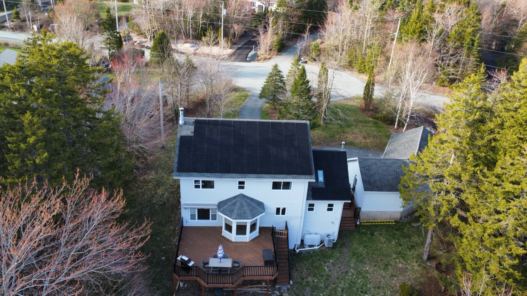 Aerial rear view of a home with a completed rooftop solar array in Hammonds Plains, Nova Scotia
